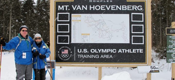 Skiers at Mt. Van Hoevenberg sign