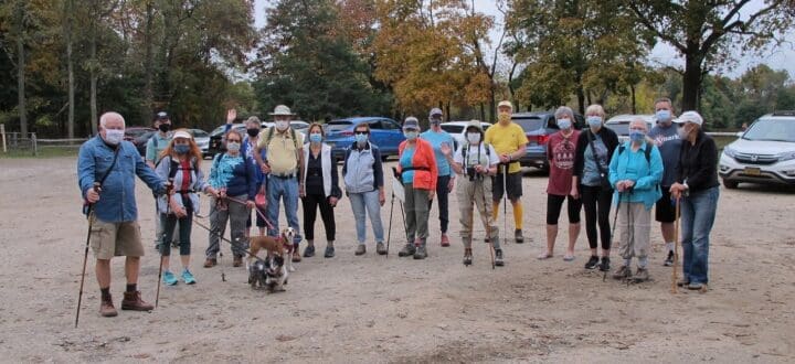 Hikers gathered in a parking area with masks