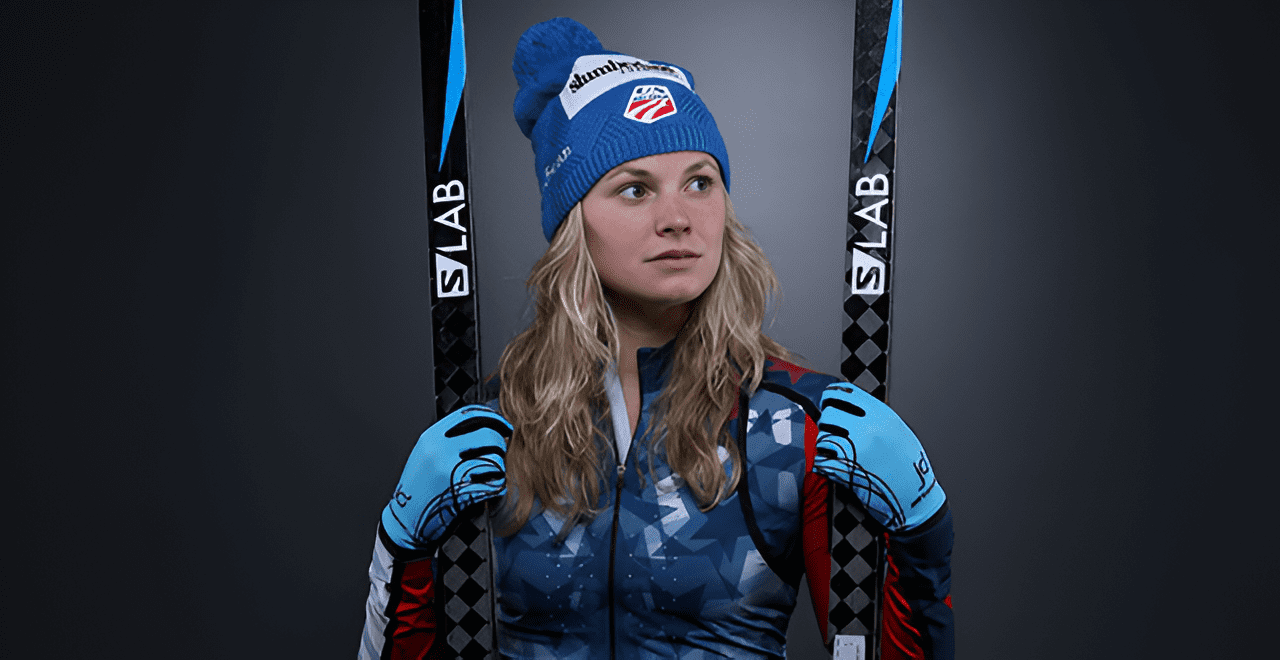 Skier posing with blue hat and skis