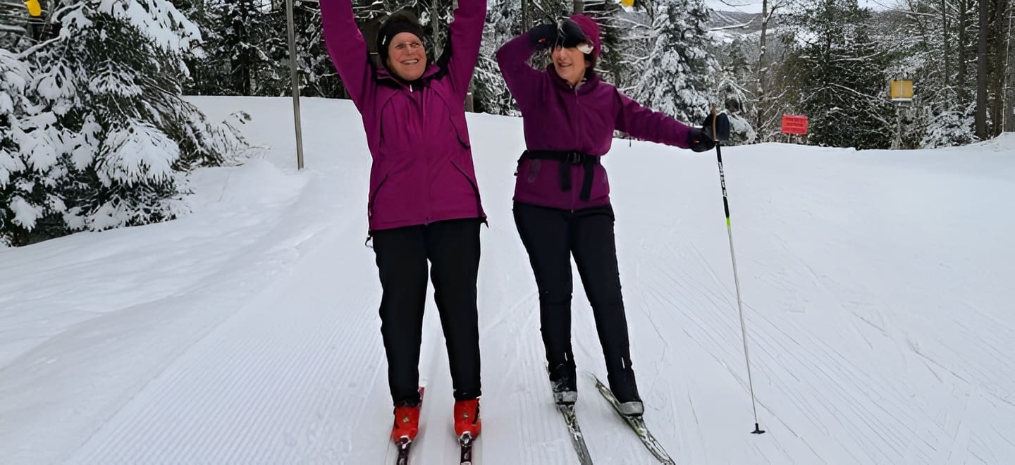 Skiers enjoying winter forest scenery