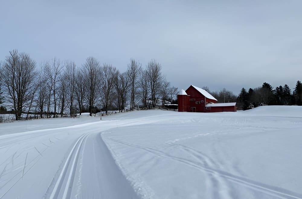 Snowy landscape with red barn